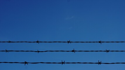 barbed wires against sky background
