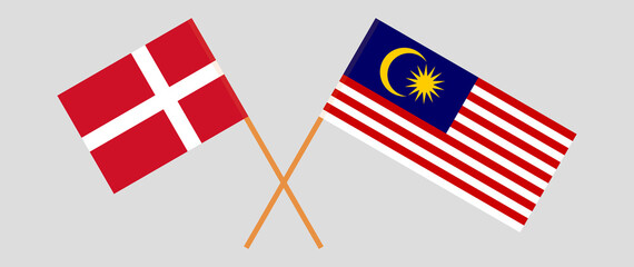 Crossed flags of Denmark and Malaysia. Official colors. Correct proportion