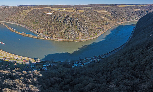Panoramic drone image of the Loreley rock on the Rhine river taken from the opposite side of the Rhine under blue sky and sunshine