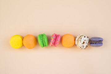 Tasty macarons on color background