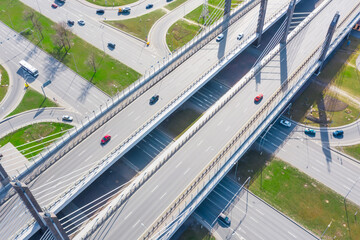 Crossroads of two major highways with cable-stayed bridge and road junction in the city, aerial view.