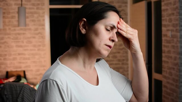 Unhappy cheerless woman having migraine