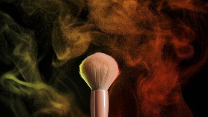 Two makeup brushes, touching each other, form a beautiful multicolored vortex of particles of...