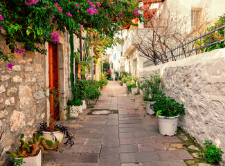 Cobbled street with white and stone walls and flowers