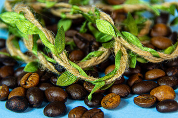 A group of coffee beans with leaves woven from straw.