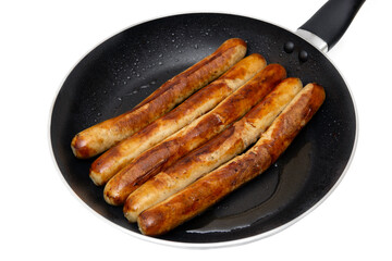 Fried german meat sausages on a frying pan isolated on white