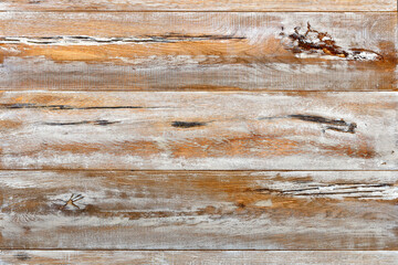 Background and texture of shabby old wooden board with cracks, knots and stains.