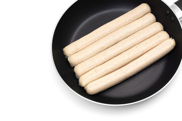 Raw german sausages on a frying pan