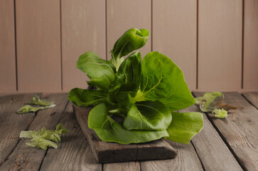 Fresh green lettuce leaves on a wooden background