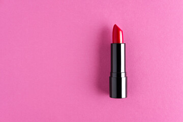 Red lipstick isolated on a fuscia background.
