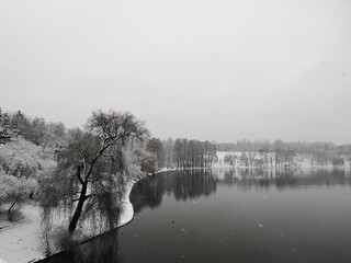 Lake in the park during wintertime  - Snow storm in the city