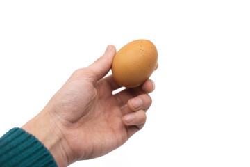 Male Hand Holding Chicken Egg Against White Background. Close Up, Studio Shot.