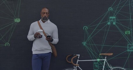 Animation of networks with digital icons over african american man using smartphone in city - Powered by Adobe