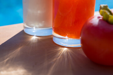 tasty persimmon dessert and natural yogurt by the pool in summer