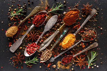 Various spices a vintage spoons on stone table. Colorful Herbal and Spices Oriental marketplace.Top...