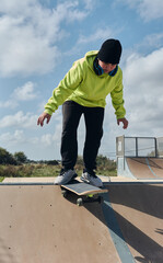 Fototapeta na wymiar young, teenager, with a skateboard, diving down the slope, on a rink, skateboarding,