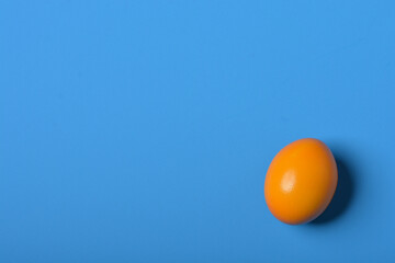 blue easter background  with yellow egg