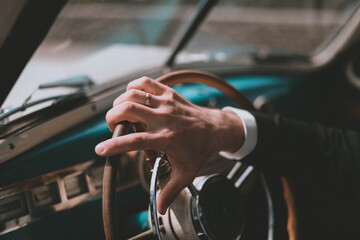 Men's hands on the steering wheel. inside a retro car. Retro style