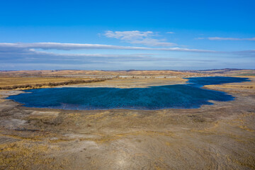 Small lake at sunny time from drone view
