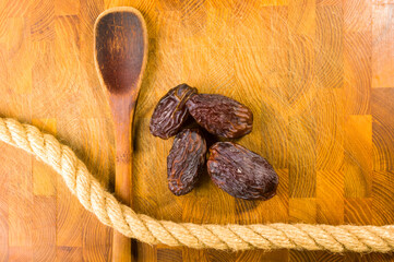 Big luxury dried date fruit on the wooden board, kurma ramadan kareem concept, close up.