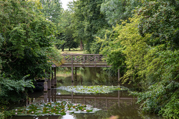 Fototapeta na wymiar an old bridge over a lake in the countryside