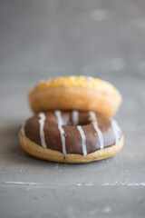 donuts yellow and chocolate Grey background