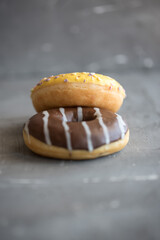 donuts yellow and chocolate Grey background