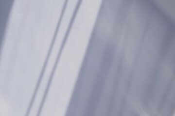 Shadows on the white wall from the sunlight falling from the window. The play of light and shadow