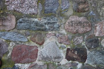 Old weathered natural stone wall background texture, ancient stonework laying