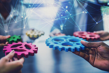 Group of people connect single colored cogwheels to make a gear. Teamwork, partnership and...
