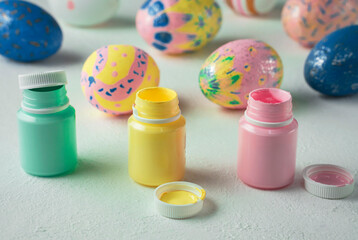 open paint cans for painting Easter eggs, selective focus