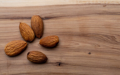 Almonds taken in close-up on a wooden background. Healthy eating and vegetarianism. The concept of healthy lifestyle.