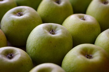 Apples stand on a wooden surface