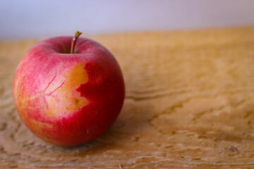 Red apple stand on a wooden surface