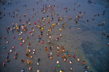 Aerial view of people working in a fishing farm with traditional fishing tool in Chatmohar, Rajshahi, Bangladesh.