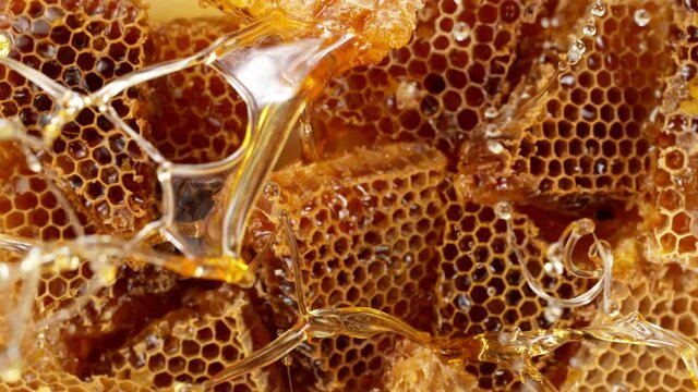 Super slow motion of splashing honey with honeycombs, top view. Filmed on high speed cinema camera, 1000 fps.
