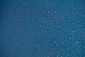 Drop dew texture. Wet water droplet on blue glass background. Bubble pattern.