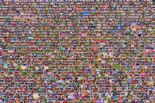 Aerial view of a vast crowd of people worshipping at Gore Shahid park in front of Eid Gah Minar religious site in Dinajpur, Rangpur, Bangladesh.