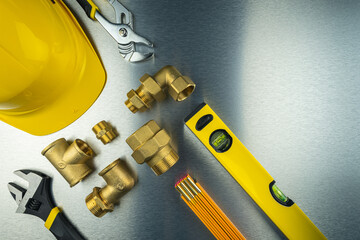 Plumbing tools and equipment on metal background