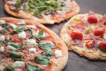 Home made pizza on dark wooden background