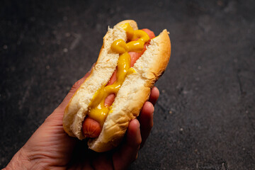 hot dog or panchito pan with sausage and mustard on black background cordoba argentina