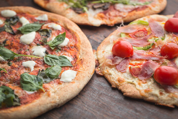 Home made pizza on dark wooden background