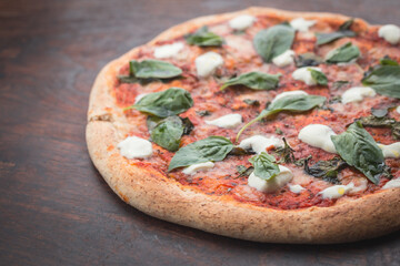Home made pizza on a wooden board