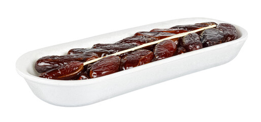 Dried dates with plastic stick in open white foam retail container isolated on white background