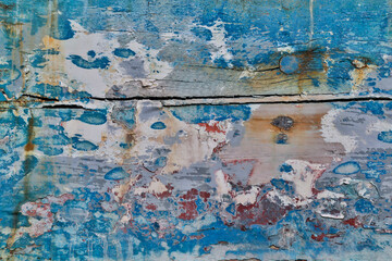 Old wooden fishing boat out of water, detail of paint. Crescent City, California.