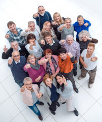 group of happy elderly people pointing at you .