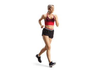 Obraz na płótnie Canvas Full length shot of a blond young female in sportswear running