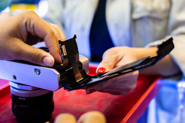 Selective focus to film camera with photographer's hand.