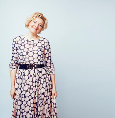 mature blond curly woman cheerful posing on white background isolated, lifestyle people concept