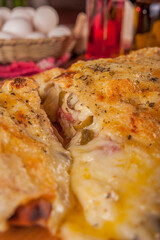 Calzone pizza with ham, cream cheese and heart of palm - Closeup.